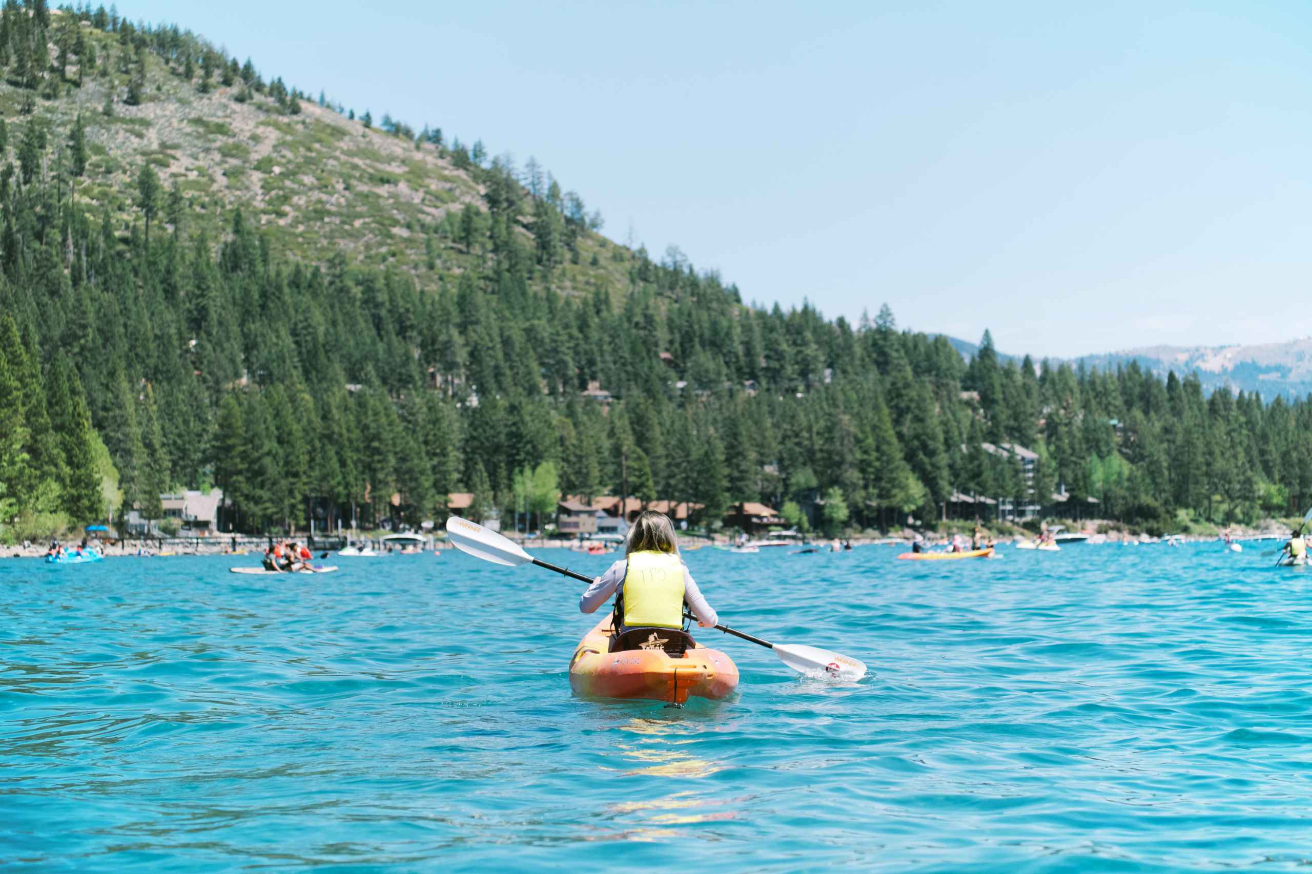 Boy swimming in a mountain lake.