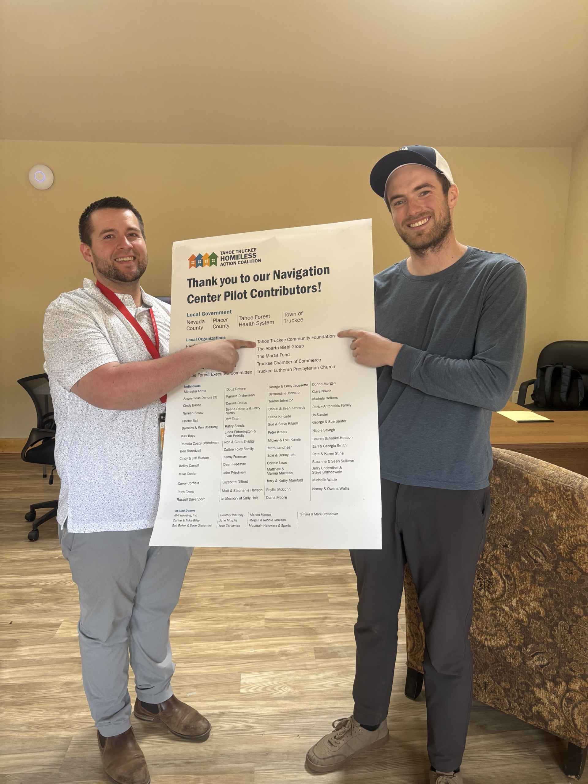 Justin Jones, Shelter Director and Josh Landheer, Whole Person Care Coordinator celebrate all the pilot contributors to the Navigation Center